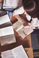 A look at the hands of a young student girl holding an open book in Ukrainian. photo