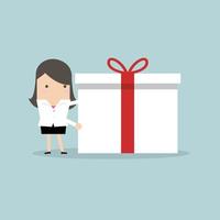 Businesswoman holding a big gift box for Christmas festival. vector