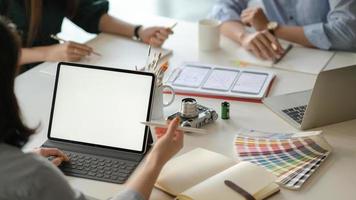 Graphic designer team uses laptops to design new projects for customers. photo
