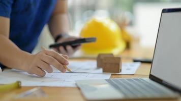 Designer is calculating and editing the house plan to present the client. photo