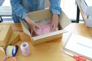 Online sellers are packing products into boxes for shipping to customers. photo