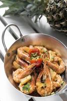 spicy sauteed asian stir fry king prawns with pineapple photo
