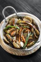 mediterranean clam and vegetable stew in pot at barcelona restaurant photo