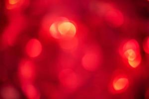 Defocus light red glare. Glitter as an abstract background. photo