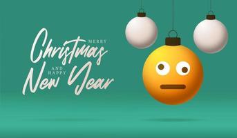 Merry Christmas card with Dizzy confused smile emoji face. Vector illustration in flat style with Xmas lettering and emotion in christmas ball hang on thread on background