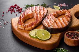 Fresh cooked delicious salmon steak with spices and herbs baked on a grill video