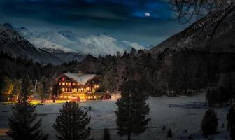 Alpin hut in snow forest photo