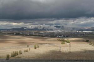 Air pollution created by the smoke coming from the chimney of the cement factory photo