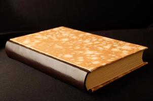 Art of Book binding. Handmade book with marble paper front and leather book spine. photo