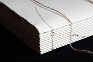 The process of book binding. Close up of a raw book after sewing on cords. photo