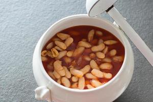 Bowl with delicious asturian fabada. Flat lay on black background. Spain photo