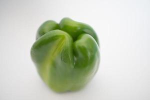 Close up of a fresh green pepper, white background photo