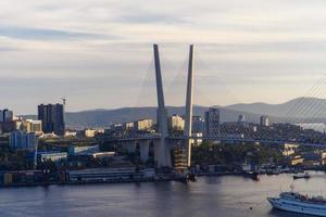 Urban landscape with a view of the Golden Bridge. Vladivostok, Russia photo