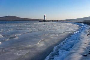 Seascape overlooking The Tokarev lighthouse against the blue sky. photo