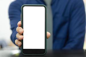 Mockup a mobile phone in the man hand. Blank screen with text or image for an advertisement. photo