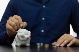 Finance concept business, collecting money for retirement or investing or sharing expenses. Drop a piggy bank. photo