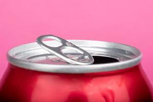 open red can tin of beer close up on pink background photo