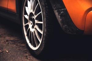 Black wheel of a yellow sports car photo