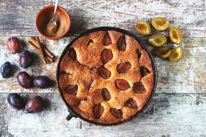 Slice of plum pie on a fork. Homemade American plum pie. photo