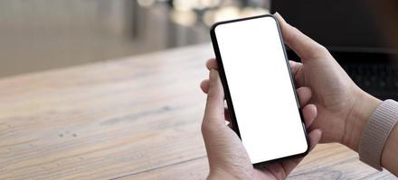 cell phone blank white screen mockup.woman hand holding texting using mobile on desk at office.background empty space for advertise.work people contact marketing business,technology photo