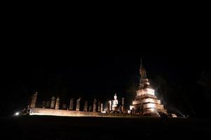 Temple at the Sukhothai Historical Park in the full moon night during the Loykratong festival, sukhothai Thailand photo