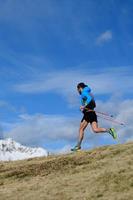 A man trains for ultra run trail in the mountains photo
