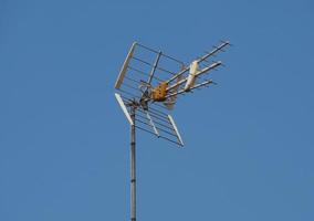 Tv antenna over blue sky with copy space photo