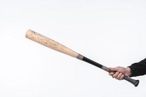 Hand holding baseball bat photo
