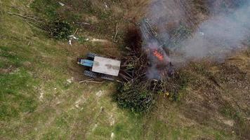 Aerial view tractor push the tree for burn video