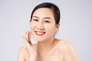 Beautiful young asian woman with clean fresh skin on white background, photo