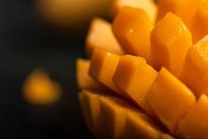 Close up of cut mango pieces against a dark background photo