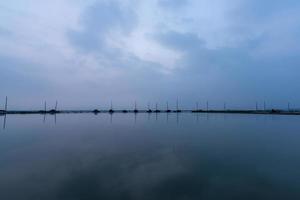 The evening lake reflected the mountains and the sky on both sides photo