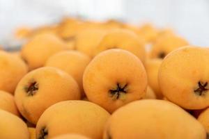 Yellow and big loquats on the plate photo