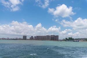 The sea and coastline under blue sky and white clouds photo