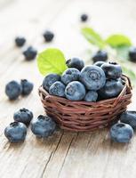 Blueberries on old wooden background photo