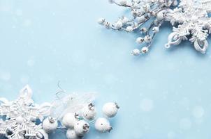 Frame made of white decorations on pastel blue background