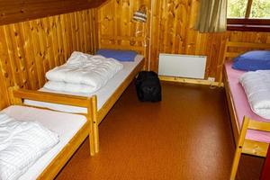 Cottage vacation interior decoration. Bedroom with beds in Norway photo