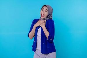 Surprised happy girl wearing hijab react to wonderful news, scream from rejoice photo