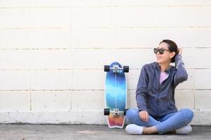 Asian woman with surfskate photo