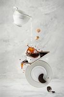 Splashing coffee with milk, cane sugar and cookie. Coffee break. Creative food photography concept.
