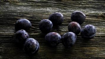 Italian plums on wooden background photo