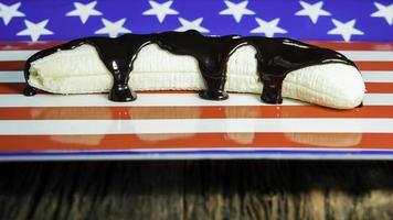 Banana with dark chocolate on american flag background photo