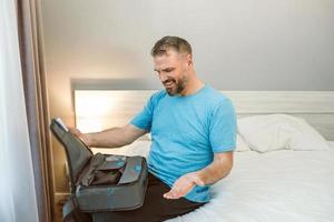 Happy rested man with chronic breathing issues after using  CPAP machine sitting on the bed in bedroom. Healthcare, CPAP, Obstructive sleep apnea therapy, snoring concept photo