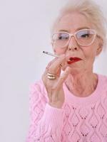 senior stylish woman smoking cigarette. Bad habit, addiction concept