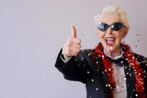 stylish mature senior woman in tuxedo celebrating new year. Fun, party, style, celebration concept photo