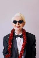 Beautiful stylish mature senior woman in sunglasses and tuxedo celebrating new year. Fun, party, style, celebration concept photo