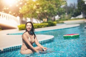 Women wear bikinis for swimming at the summer recreation pool photo