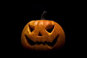 Halloween pumpkin on black background photo