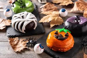 Assortmen of Halloween donuts and autumn leaves photo