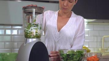 Girl preparing drink with spinach. video